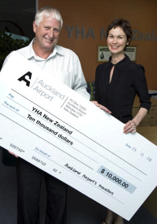YHA CEO Mark Wells and staff member Shelley Keach are all smiles about Auckland Airport's $10,000 donation.