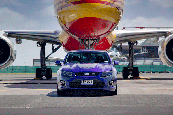 car photoshoot in front of DHL plane
